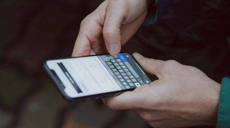 man in white dress shirt sitting beside woman in black long sleeve shirt